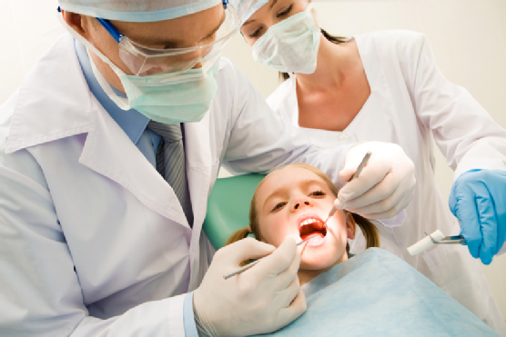 young girl being checked by her dentist