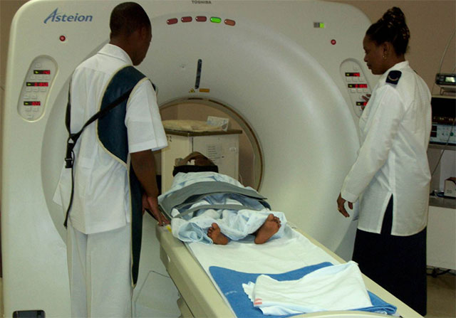 Two person helping patient to have a ct scan