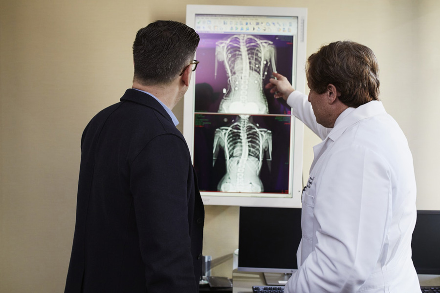Doctor explaining a graphic of a human body to his healthcare administrator